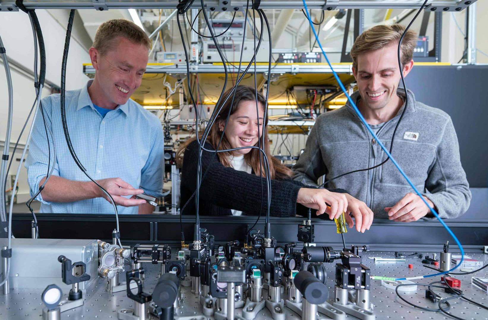 David Weld in his lab with 2 students