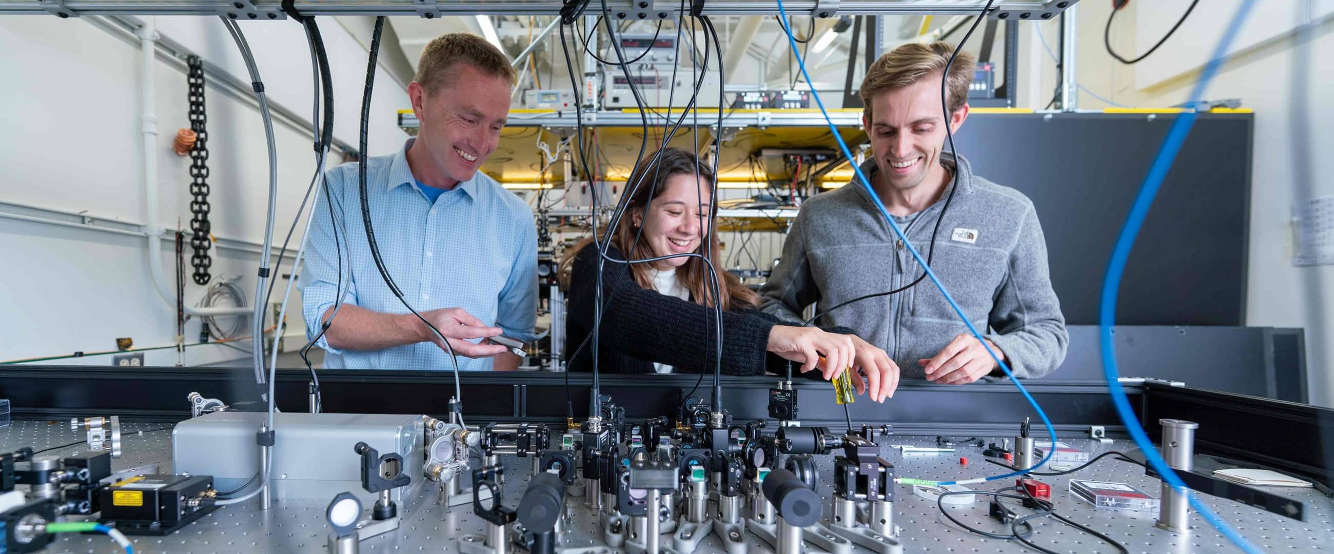 David Weld in his lab with 2 students